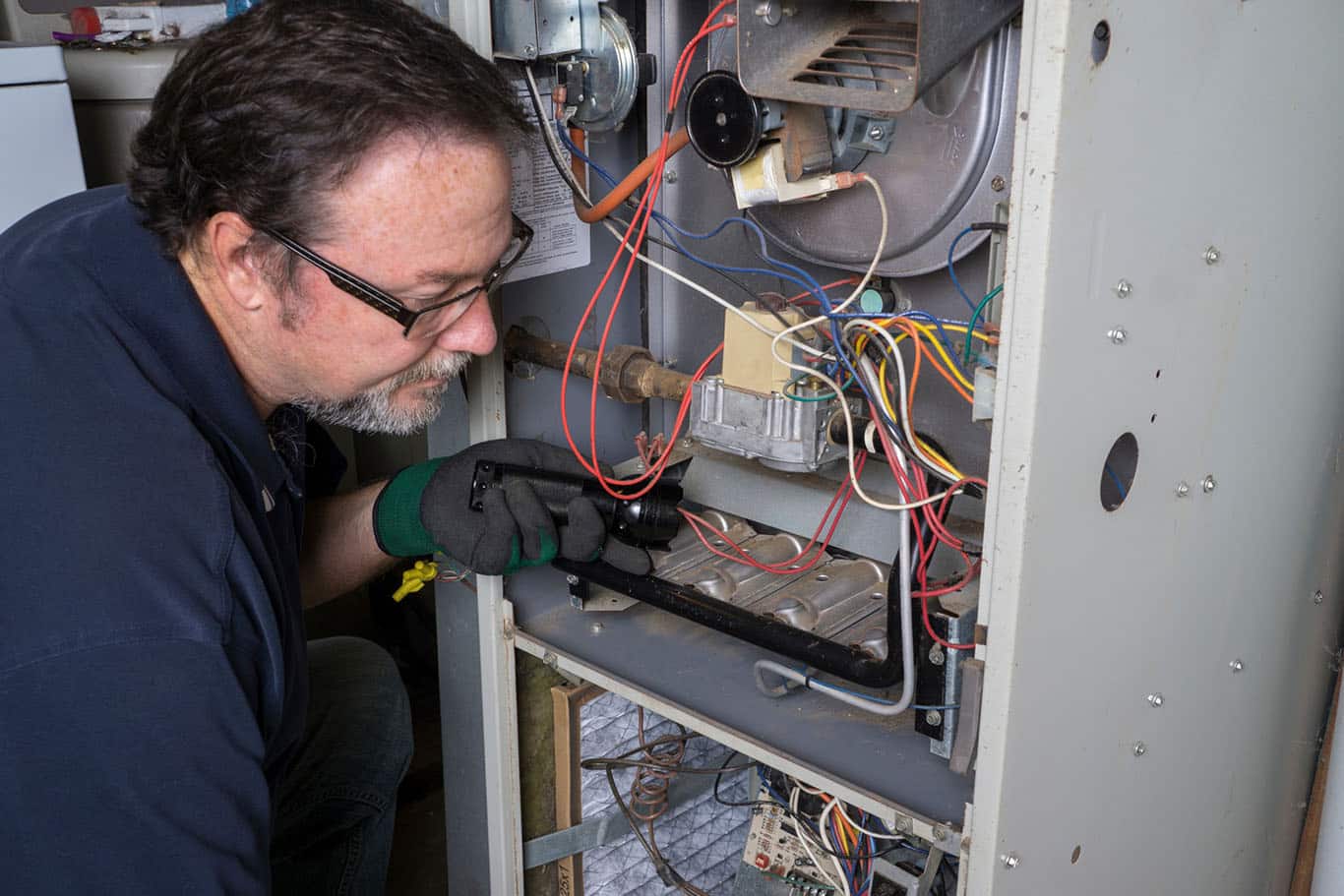 Technician preforming heating repair in St. George