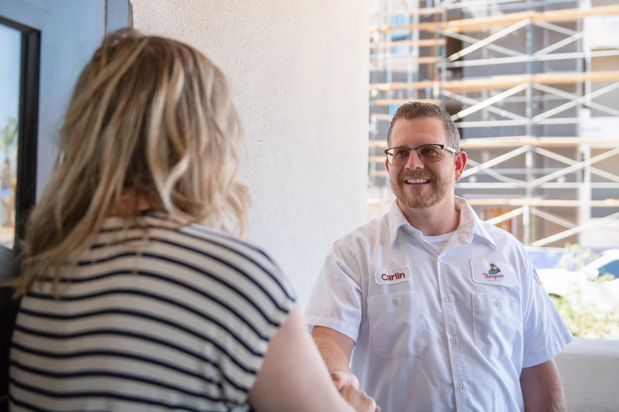 Thompson Plumbing technician Carlin greeting a customer with a handshake in St. George Utah
