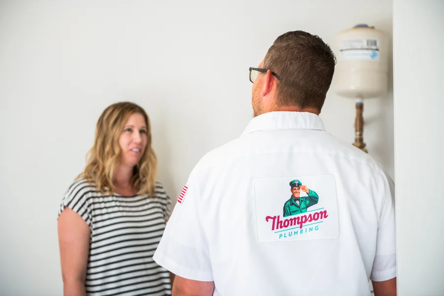 Thompson Plumbing technician consulting with a St. George Utah homeowner during a service visit