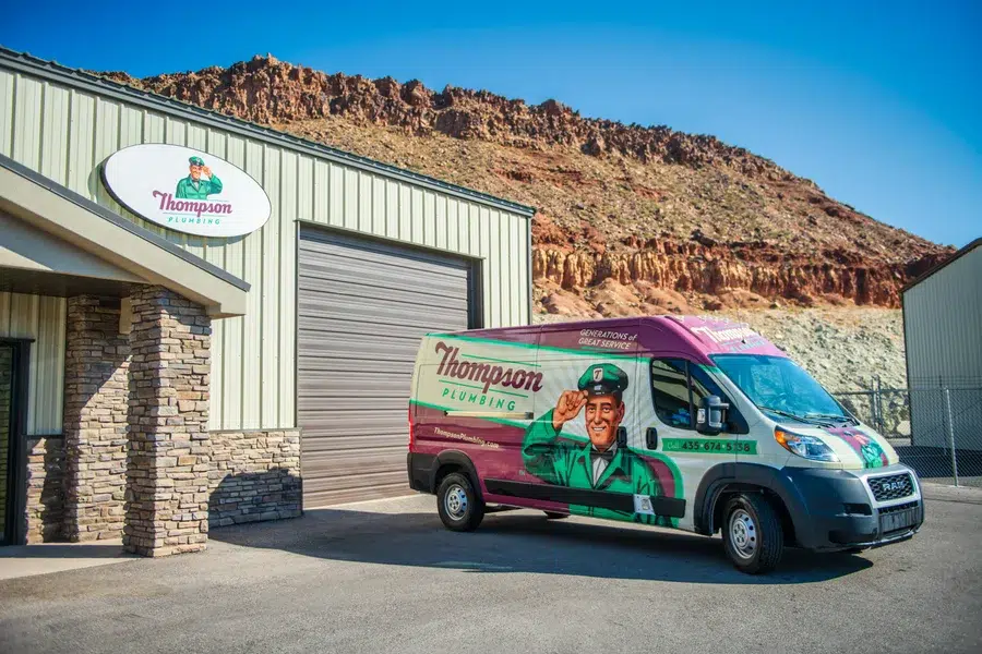 Thompson Plumbing office and service van in St. George Utah with red rock cliffs visible in the background