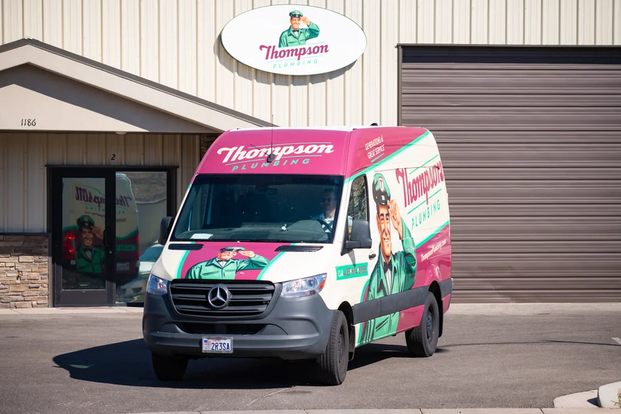 Thompson Plumbing Sprinter service van pulling out of the company's Cedar City Utah office location ready for a service call