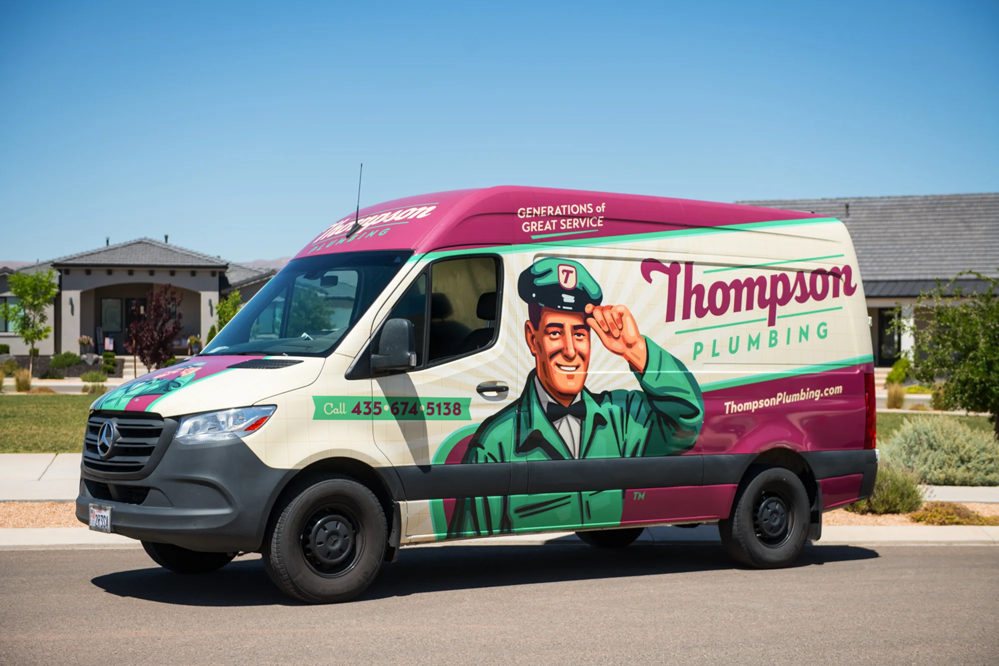 Thompson Plumbing service van parked in a St. George Utah residential neighborhood on a sunny day