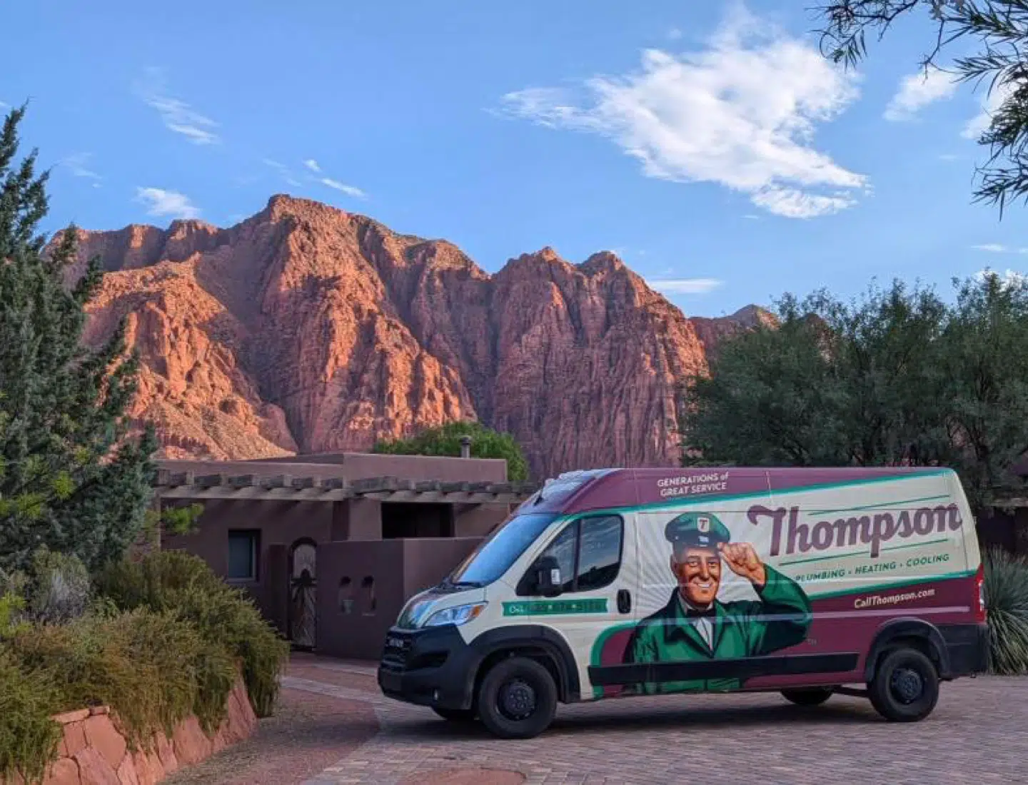 Thompson Plumbing Heating Cooling and Electric service van near St. George Utah in Red Mountain rising behind the Kayenta community in Ivins, Utah.