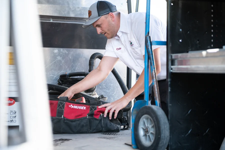 Thompson Plumbing technician Cole loading plumbing tools and equipment into the service van before a St. George Utah call
