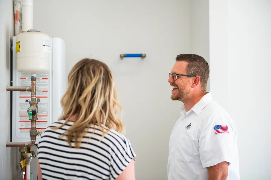 Thompson tech smiling with homeowner during service call in St George area home