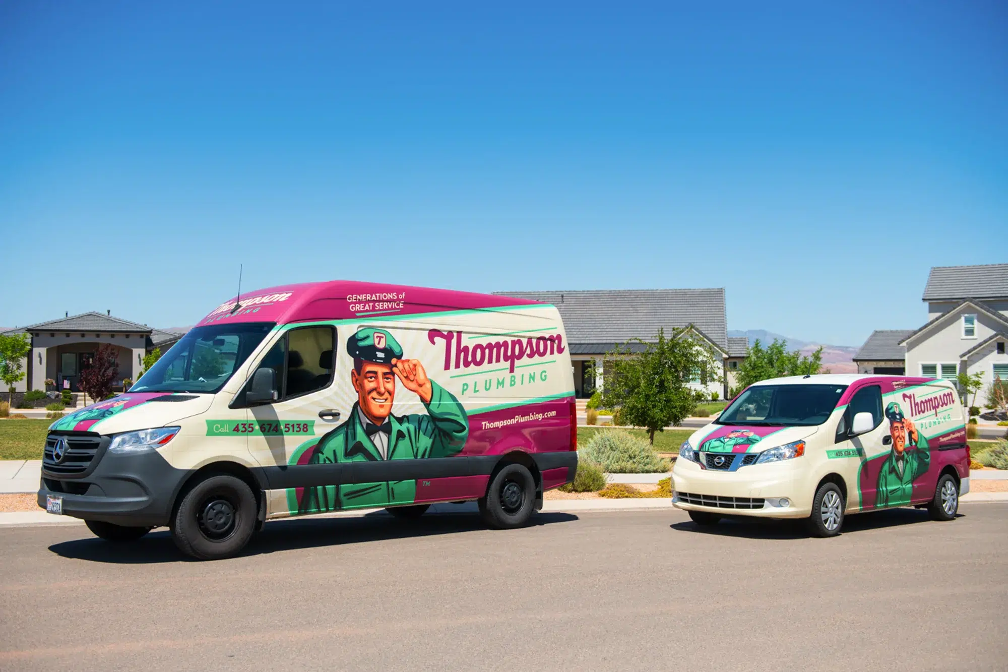 Two Thompson Plumbing vehicles — parked side by side in a sunny St. George area neighborhood