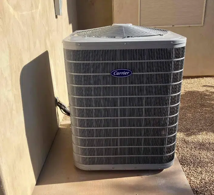 Carrier central air conditioning unit installed by Thompson on a concrete pad in St. George, Utah.