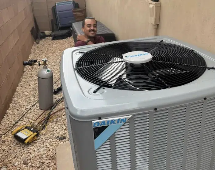 Thompson technician completing a Daikin AC unit installation in a St. George, Utah residential backyard.