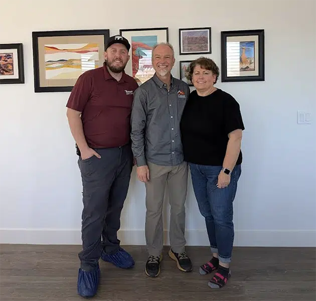 Thompson AC technician with satisfied homeowners after AC repair